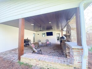 Relax by the fireplace and enjoy the outdoors with a grill and comfortable seating for two.