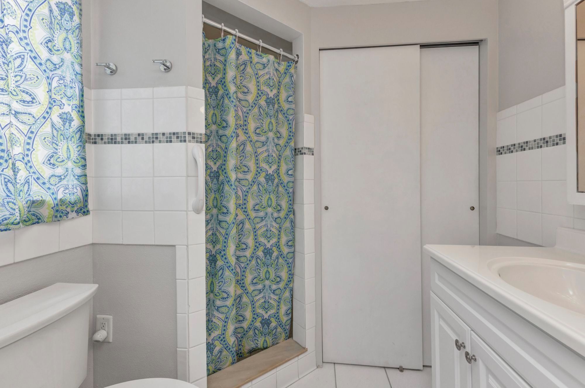 Un baño con ducha, inodoro y lavabo.
