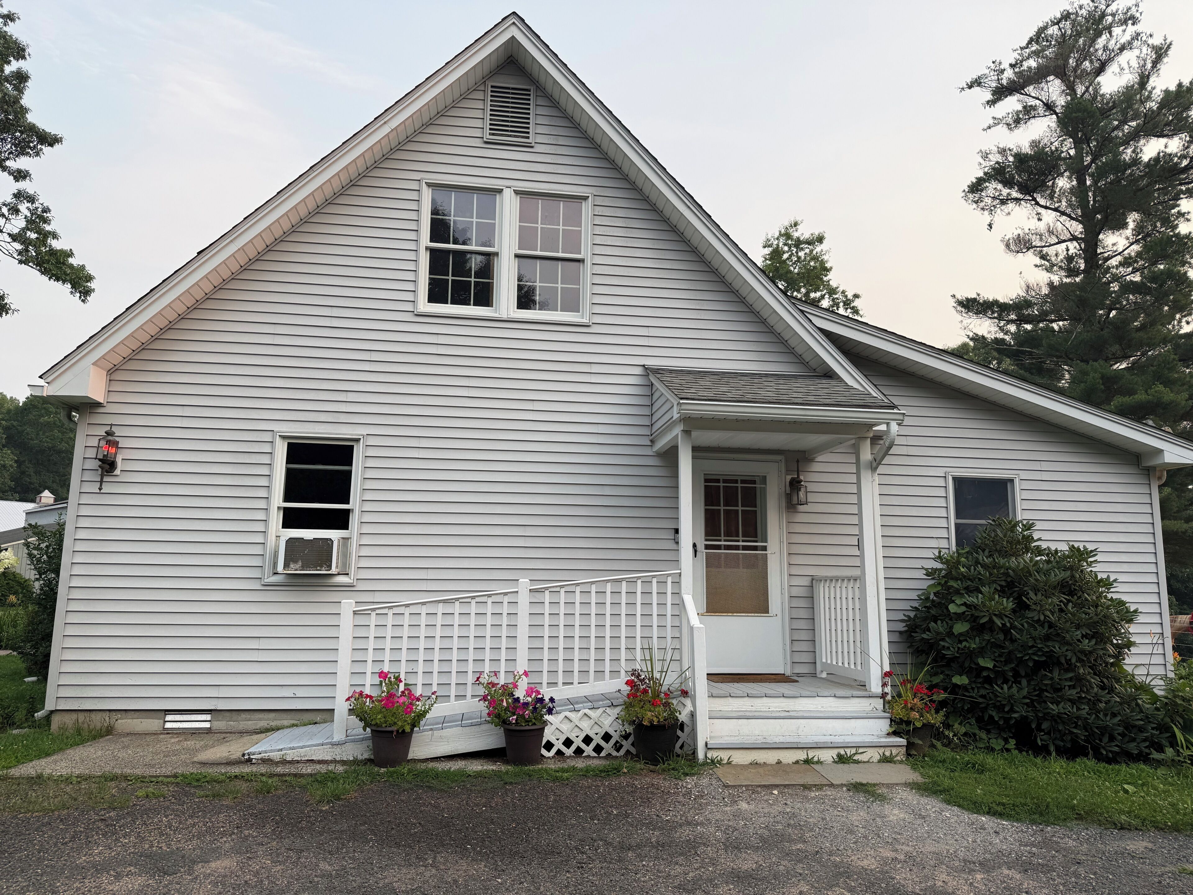 A single-story house with a front porch, a small entryway, and a window.