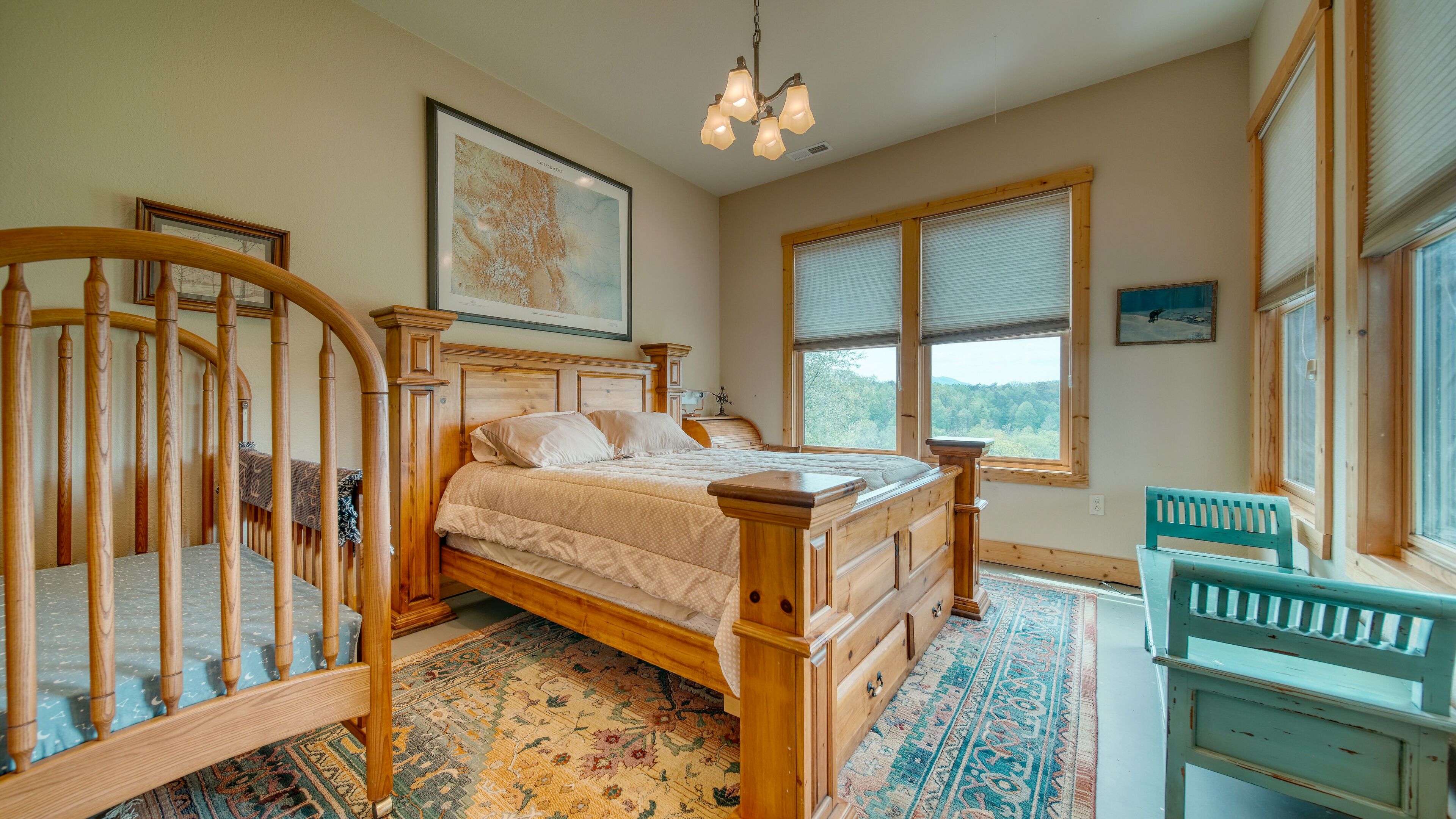 Downstairs bedroom with Queen bed and crib.