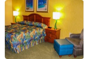 Cozy retreat with a neatly made bed, two bedside tables, and a comfortable chair.