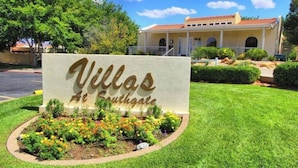 A sign for Villas at Southgate with a well-manicured lawn and a building in the background. - 2 bedroom private villa, with pools & hot tubs! (St. George)