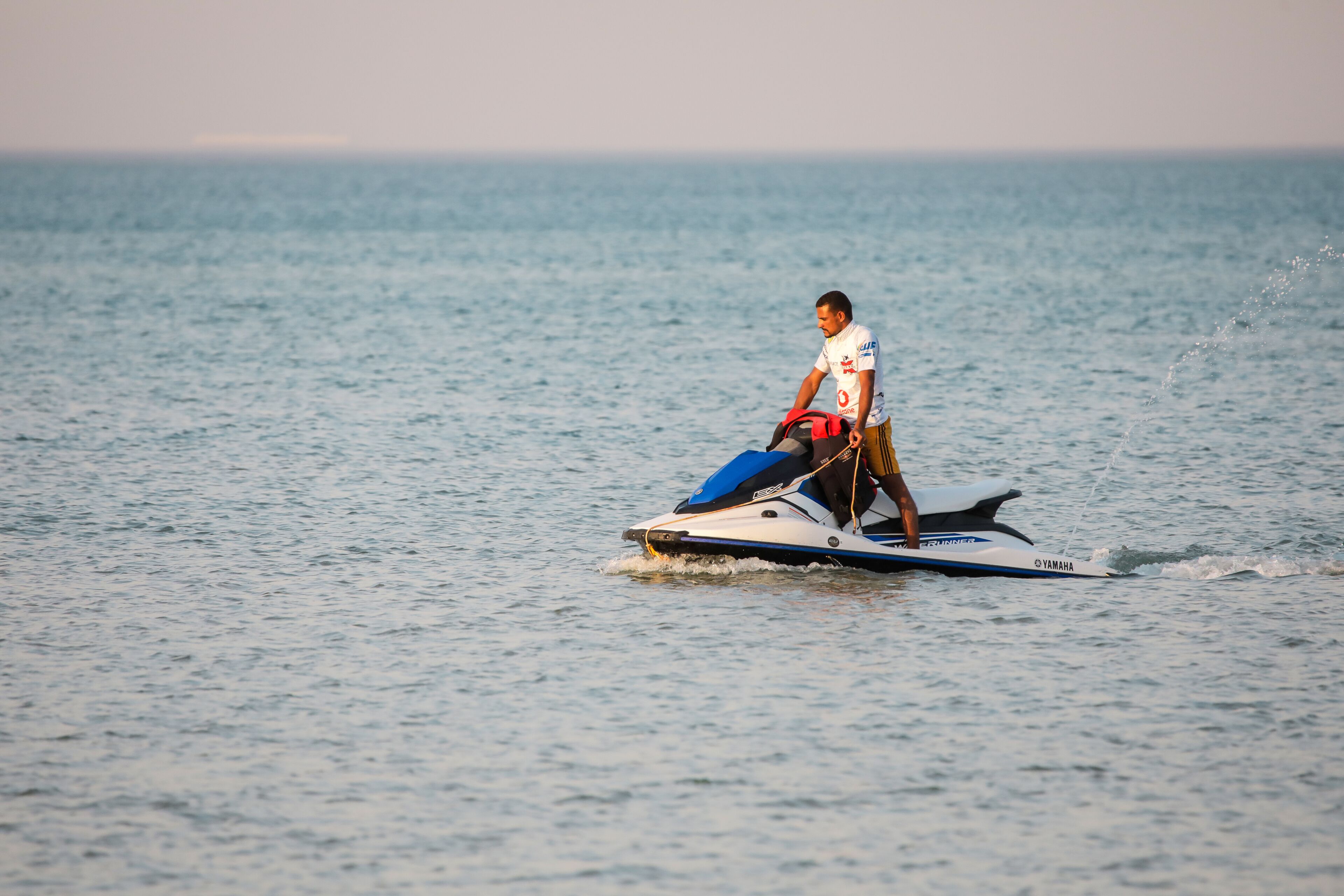 A person riding a jet ski on a body of water.