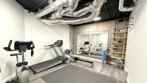 A gym with a treadmill, elliptical, and weights. - Private Vacation Resort:  Pool,  Spa, Gym, Kitchen, Laundry, in Tranquil Setting (Sugar Hill)