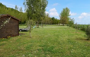 Escape to a peaceful retreat surrounded by nature, with a cabin and playground nearby.