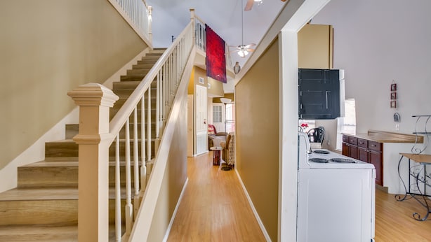 A staircase with wooden steps and white railings leading to a second floor. - Quiet, Quirky Country Escape Near Pearl River! (Angie)