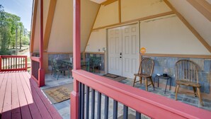 A covered porch with a red railing, a ceiling fan, and two wooden chairs. - Unique Country Getaway in Angie w/ Covered Patio! (Angie)