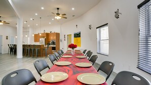 A dining area with a long table set for six, surrounded by black chairs. - Unique Country Getaway in Angie w/ Covered Patio! (Angie)