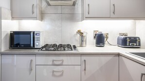 A modern kitchen with a gas stove, a microwave, and a toaster. - 5* Ultra Luxury, Great Views, Underground Parking (Belfast)