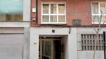 A building entrance with a glass door, a brick facade, and a number '11' above the door.