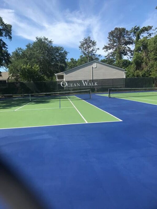 A tennis court with a building labeled "Ocean Walk" in the background. - A13 Charming 1 BR, 1 BA, queen bed on ground level (St. Simons Island)