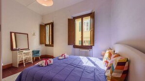 A bedroom with a bed, a desk, a chair, a window, and a radiator. - Santa Maria Novella Classic by Mmega (Firenze)