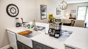 A modern kitchen with a built-in dishwasher, a coffee maker, and a sink. - 🌄Resort Vacations at Fairfield Glade TN (Fairfield Glade)
