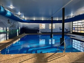 Relax by the pool surrounded by a serene mountain landscape.