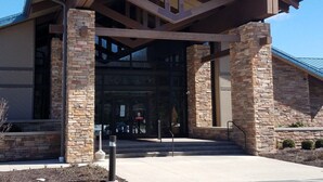 A building with a covered entrance, stone pillars, and a parking lot. - Arrowhead Lake Retreat with large deck and fire pit (Pocono Lake)