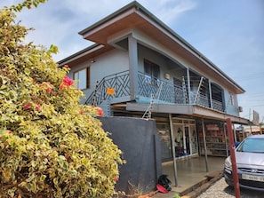 A two-story building with a balcony and a covered entrance. - Lovely & Cute Condo - Close to Highway - Parking (Accra)