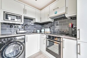 Enjoy cooking and dining in this fully equipped kitchen with appliances and ample countertop space.