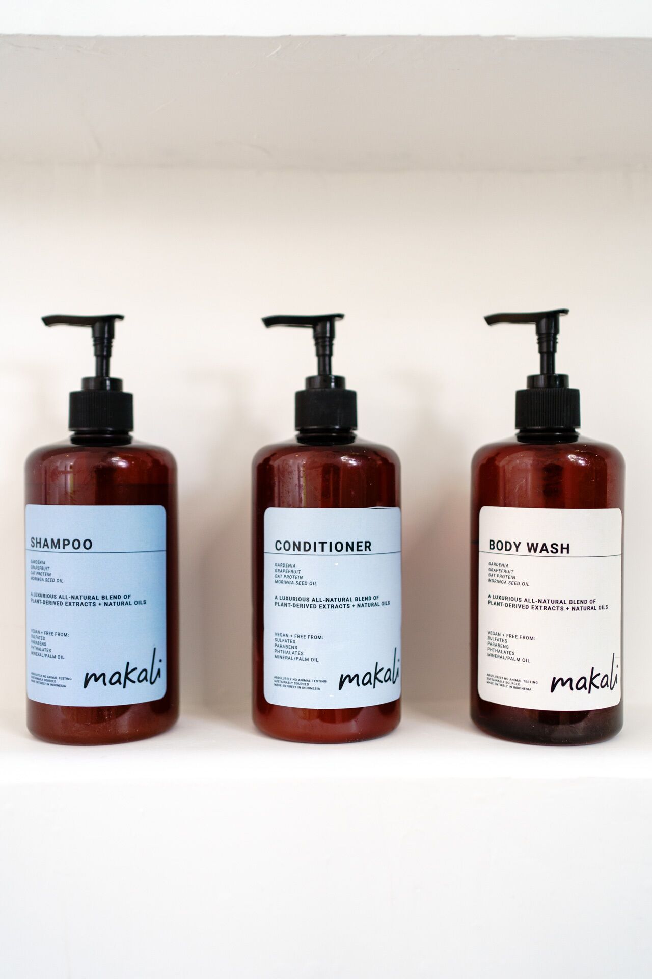 Three bottles of Makali products: Shampoo, Conditioner, and Body Wash.