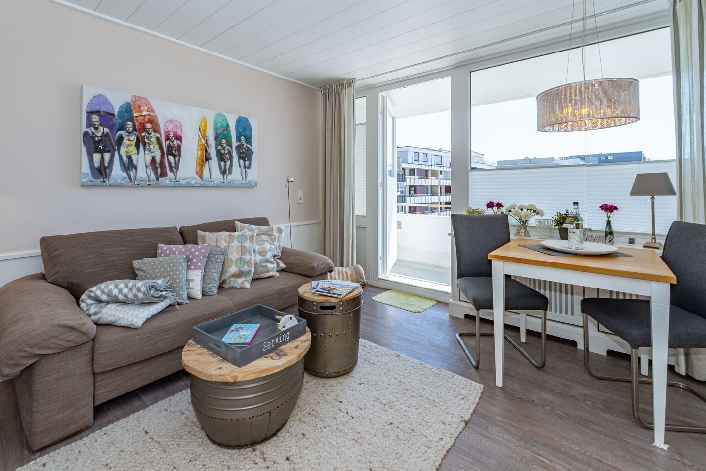 A modern living room with a sofa, coffee table, and dining area.