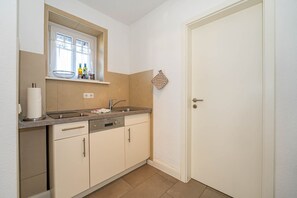 Fridge, stovetop, dishwasher, coffee/tea maker