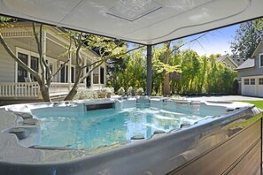 A hot tub in a covered outdoor area with a view of a house and trees. - The Beautiful Armstrong Estate Downtown Sonoma (Sonoma)