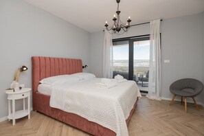 A bedroom with a bed, bedside table, chair, and a view through a window. - Villa HILL Grubine - NEW - with pool (Grubine)