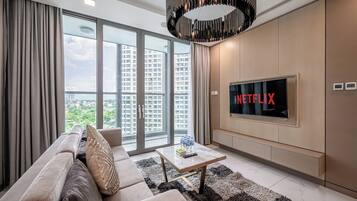 Deluxe Apartment, 3 Bedrooms, Balcony, City View | Living area | 32-inch Smart TV with digital channels, TV