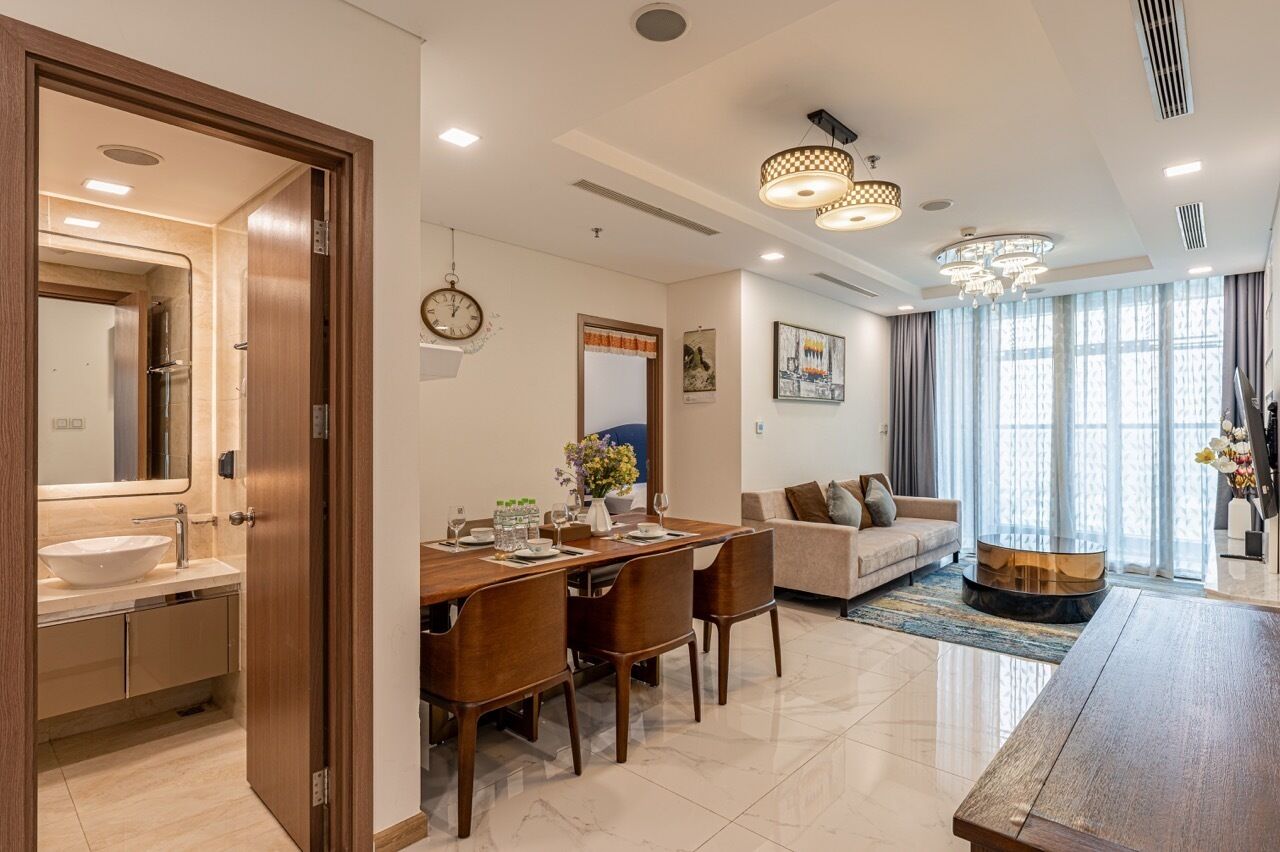 A modern living room with a dining area, a sofa, and a coffee table.