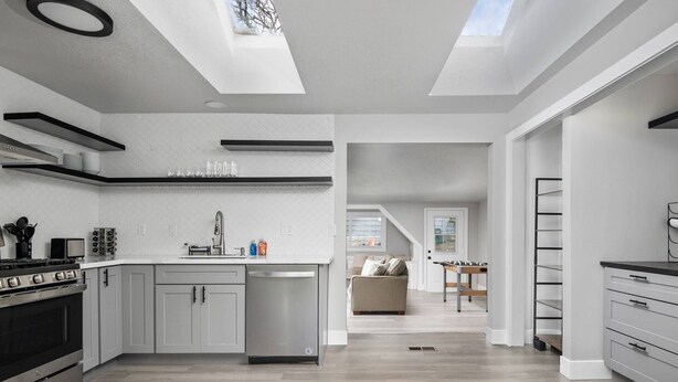 A modern kitchen with a central island, built-in appliances, and skylights. - Spectacular Single Level Estate, Pet Friendly, Huge Fully Fenced Backyard, Covered Patio, Game Room (Portland)