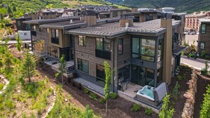 A modern multi-story residential building with large windows, a rooftop garden, and a swimming pool. - Encore by AvantStay | Minutes from the Slopes in PC! w/ Hot Tub (Park City)