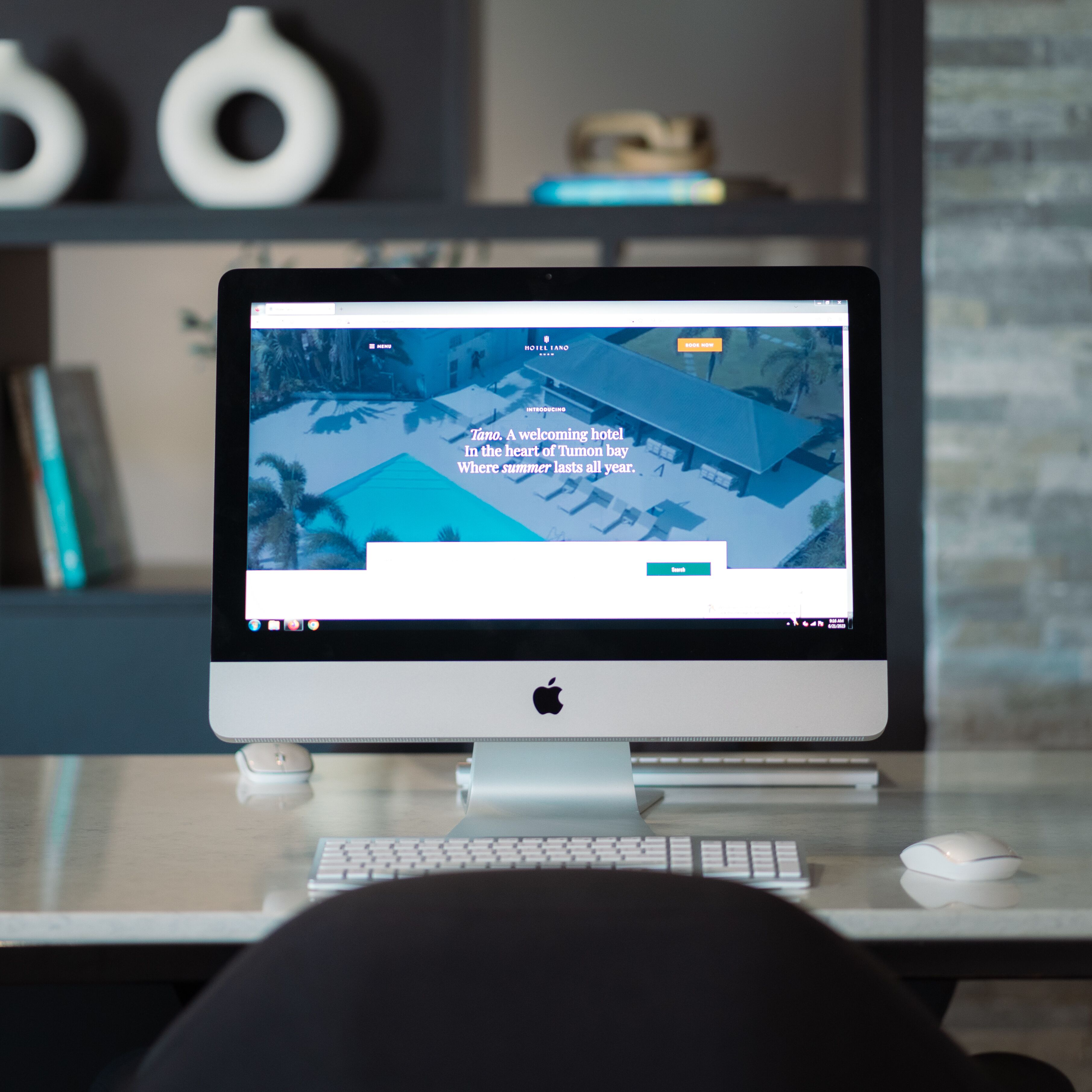 A desktop computer displaying a hotel website with a snowy landscape view.
