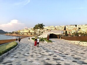 A paved walkway with a geometric pattern, leading to a building with a curved entrance. - TEDDY 108 HOMESTAY & CAFE - GRAND WORLD PHU QUOC (Phu Quoc)