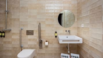 Un baño moderno con inodoro, lavabo y ducha.