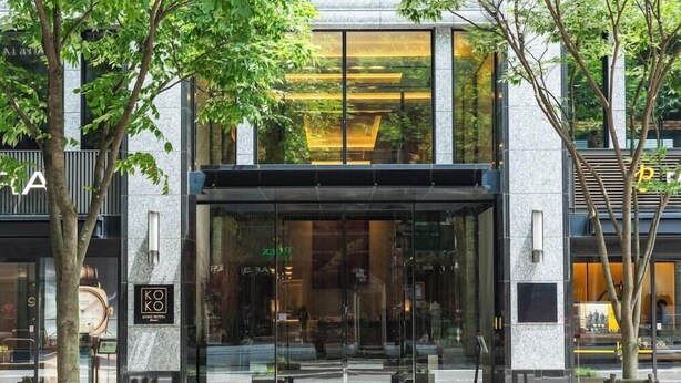 A modern hotel entrance with large glass doors, a visible clock, and a sign reading "KOKO HOTEL". - Koko Hotel Premier Kanazawa Korinbo (Kanazawa)