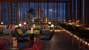 A rooftop lounge with seating areas, tables, and a view of the city skyline at dusk. - Dusitd2 Samyan Bangkok (Bangkok)