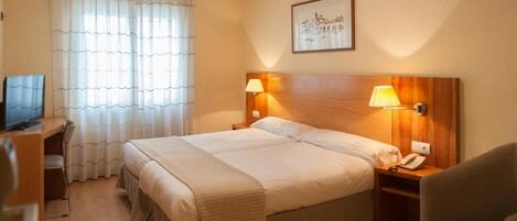 Hypo-allergenic bedding, down duvets, desk, laptop workspace