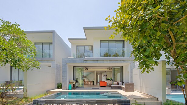 A modern two-story house with a swimming pool, a glass-enclosed patio, and a well-maintained lawn. - The Point Villa Da Nang (Da Nang)