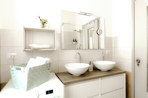 Hair dryer, bathrobes, bidet, towels