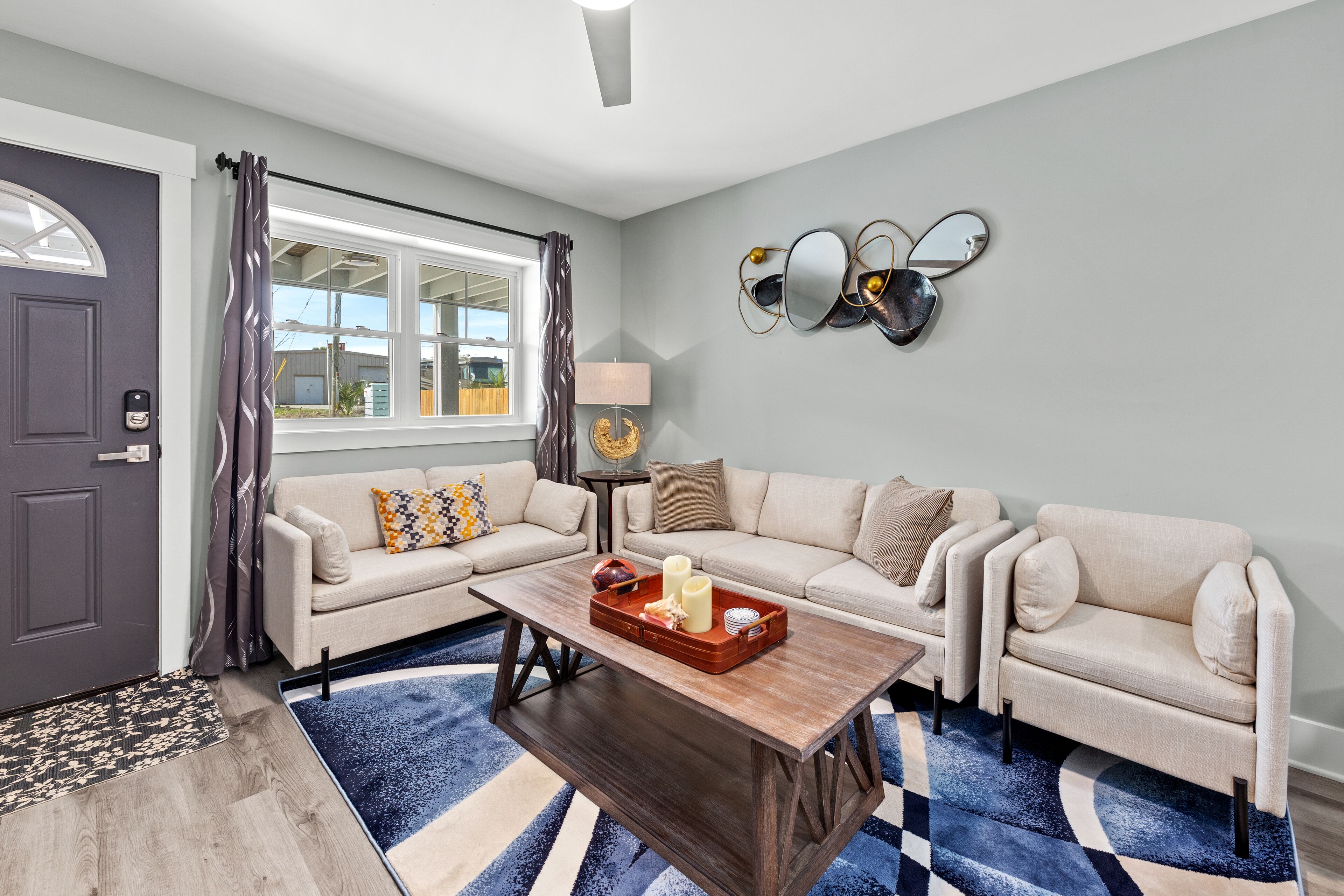 A modern living room with a sofa set, a coffee table, and decorative wall art.