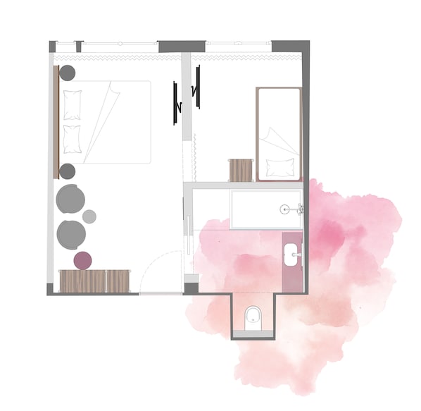 Plano de planta de una habitación de hotel con cama, baño, una pequeña zona de estar y kitchenette.