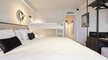 Una habitación de hotel moderna con una litera, un escritorio y un armario.