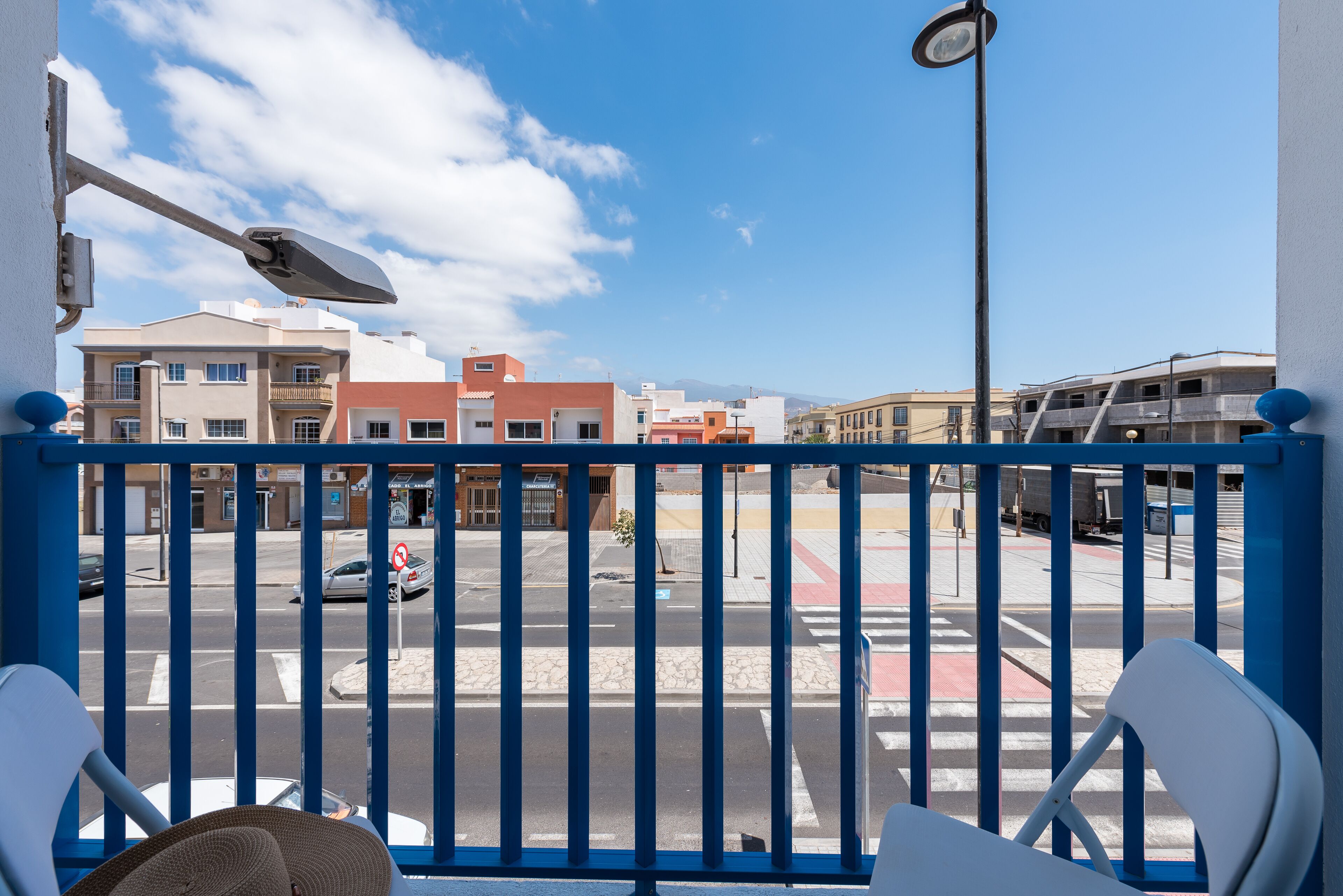 A balcony with a view of a street and buildings.