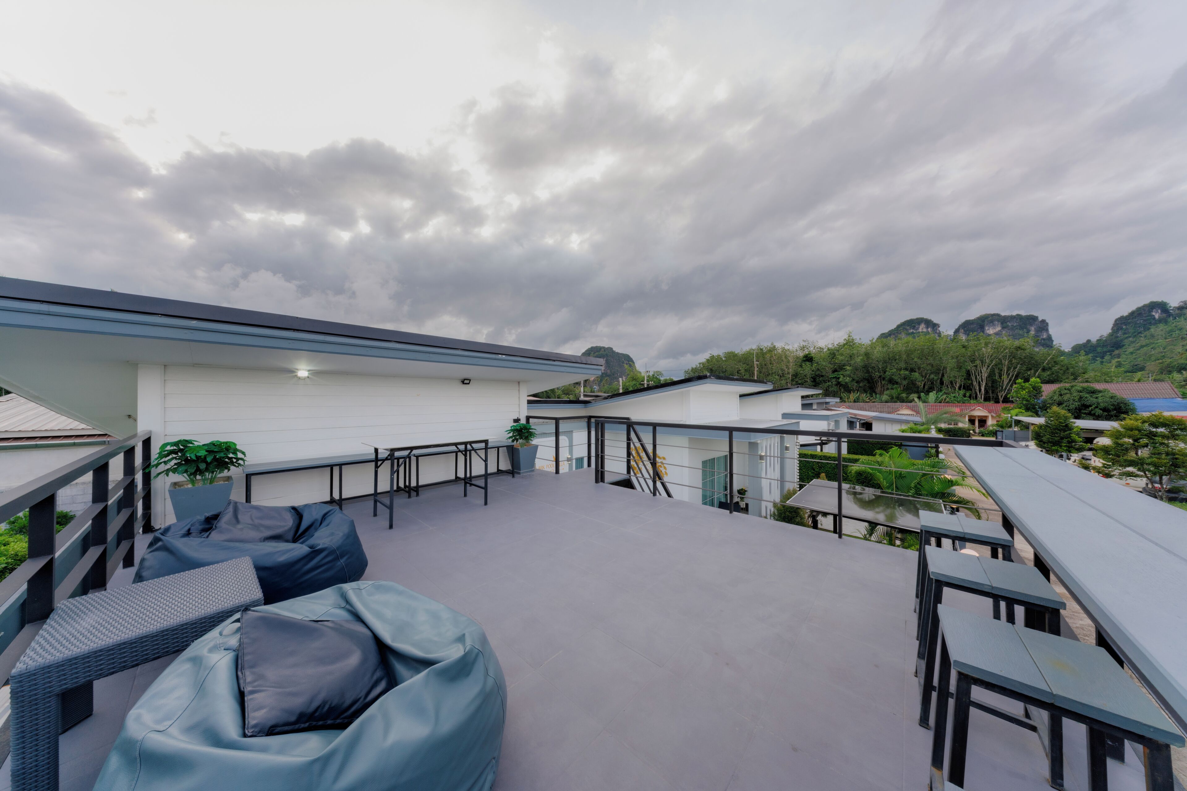 A rooftop terrace with outdoor seating and a view of the surrounding landscape.