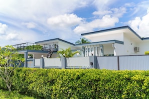 A modern two-story house with a balcony, a covered outdoor area, and a gated entrance. - Lark Pool Villa Krabi (Krabi)