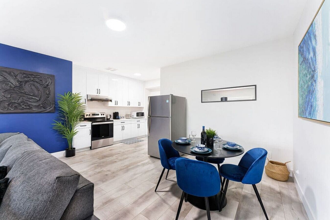 A modern apartment with a dining area, kitchen, and living room.