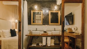 A bathroom with two sinks, a mirror, and a wooden vanity. - Agua Santa Hotel Boutique (San Miguel de Allende)