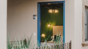 A room with a bed, a nightstand, a lamp, and a hanging light fixture. - Agua Santa Hotel Boutique (San Miguel de Allende)