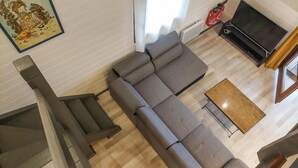 A living room with a grey sectional sofa, a small coffee table, a flat-screen TV, and a staircase. - 3 bedroom lovely home in Sainte Croix-Volvestre (Sainte Croix-Volvestre)