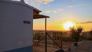 A wooden deck with a glass balustrade overlooking a sunset. - Monte Sardinha (Santiago do Cacém)