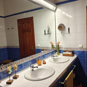 A bathroom with two sinks, a mirror, and a wooden door. - A beautiful, luxurious villa with a private pool and stunning views (Dénia)